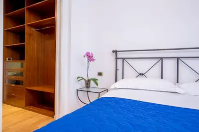 a bedroom with a blue bed and a closet at Dream House Vaticano in Rome