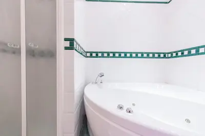 a white bathroom with a sink and a mirror at Dream House Vaticano in Rome