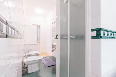 a white bathroom with a toilet and a sink at Dream House Vaticano in Rome
