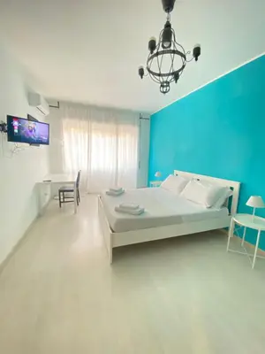 a bedroom with a large bed and a blue wall at Rizzo St. Peter apartment in Rome