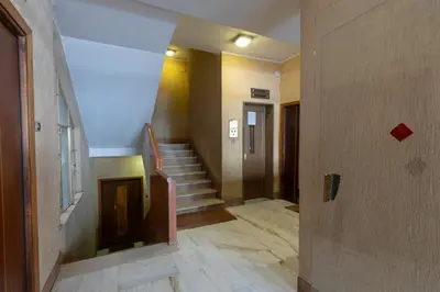 an empty hallway with stairs in a building at Rizzo St. Peter apartment in Rome