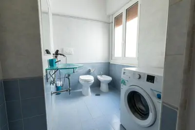 a bathroom with a washing machine and a toilet at Rizzo St. Peter apartment in Rome