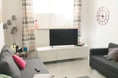 a living room with a couch and a flat screen tv at CRIS - close to VATICAN - Centre&StadiumArea in Rome