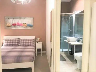 a bedroom with a bed and a bathroom with a sink at CRIS - close to VATICAN - Centre&StadiumArea in Rome