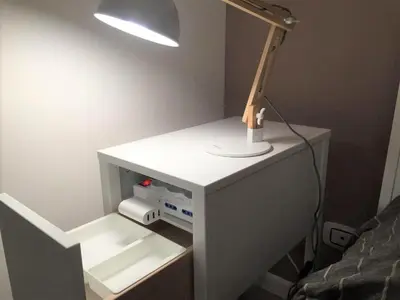 a desk with a lamp on it next to a bed at CRIS - close to VATICAN - Centre&StadiumArea in Rome