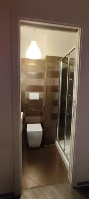 a bathroom with a shower with a tile wall at Vatican City San Peter quiet and lovely apartment in Rome