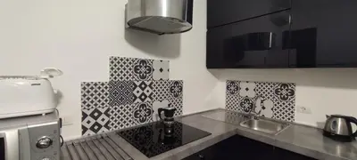 a stainless steel sink in a kitchen with black and white wallpaper at Vatican City San Peter quiet and lovely apartment in Rome
