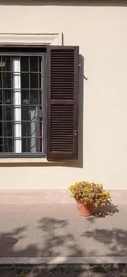 a fence in front of a building with a car at Vatican City San Peter quiet and lovely apartment in Rome