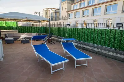 a group of blue chairs and tables on a patio at Pandy Suite in Rome