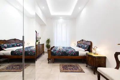 a bedroom with two beds and a mirror at Circus Maximus n 1-at 400m Metro in Rome