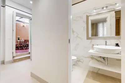 a bathroom with a sink and a mirror at Trevi Chic House in Rome