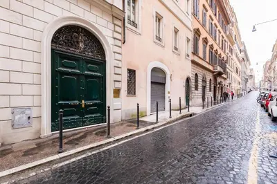 a green door on the side of a building on a street at Trevi Chic House in Rome