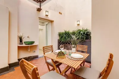 a dining room with a wooden table and chairs at Trevi Chic House in Rome