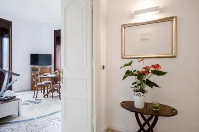 a room with a table with a plant and a picture at Flat Six in Rome