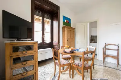 a dining room with a table and a television at Flat Six in Rome