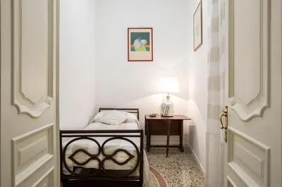 a bedroom with a bed and a table with a lamp at Flat Six in Rome