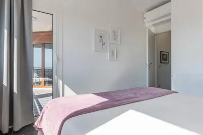 a white room with a bed and a window at Nomentana White Apartments in Rome