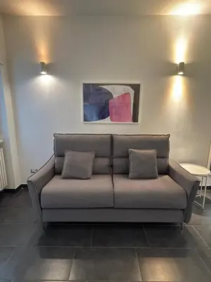 a couch in a living room with two pillows at Nomentana White Apartments in Rome