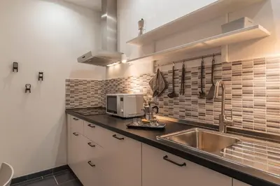 a kitchen with a sink and a microwave at Nomentana White Apartments in Rome