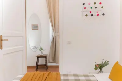a white room with a door and a mirror at New! Spanish Step Design Apartment in Rome