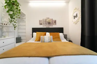 a bedroom with a large bed with yellow pillows at *****AmoRhome***** New Luxury apartment in the heart of Rome in Rome