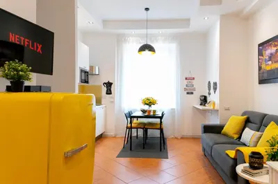 a living room with a couch and a yellow refrigerator at *****AmoRhome***** New Luxury apartment in the heart of Rome in Rome