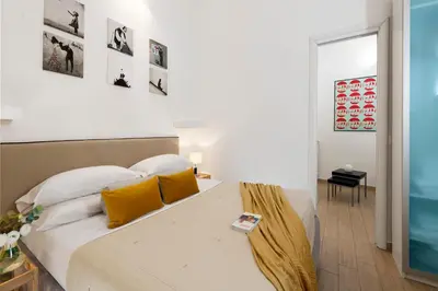 a bedroom with a large bed with yellow pillows at Grotte Apartment near Campo dé Fiori in Rome