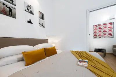 a bedroom with a large bed with yellow pillows at Grotte Apartment near Campo dé Fiori in Rome