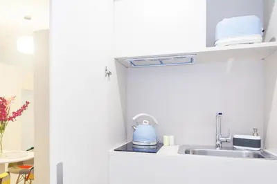 a kitchen with a sink and a blue tea kettle at Casa Bella Pantheon in Rome