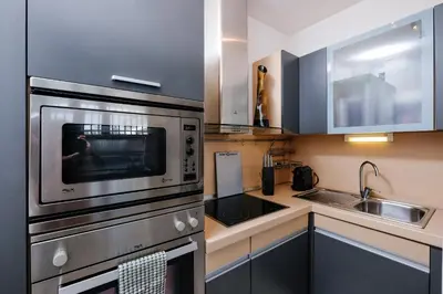 a kitchen with a stainless steel oven and a sink at Amazing Penthouse with Terrace by Caracalla in Rome