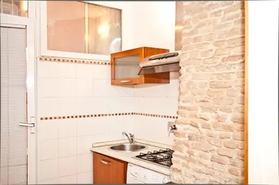 a small kitchen with a sink and a stove at The heart of Trastevere in Rome