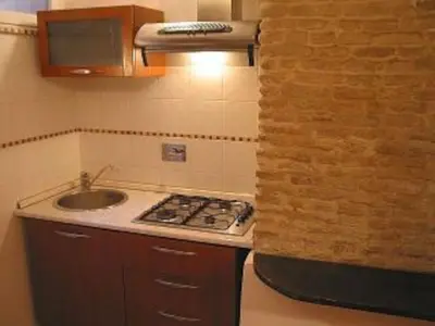 a kitchen with a sink and a counter top at The heart of Trastevere in Rome