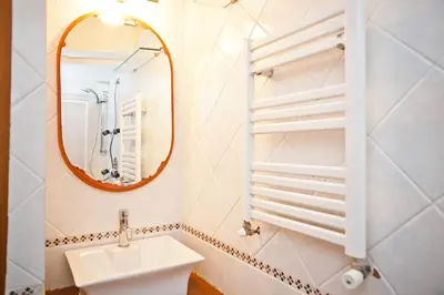 a bathroom with a sink and a mirror at The heart of Trastevere in Rome