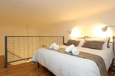 a bedroom with a large bed with towels on it at Mr Frills in Rome