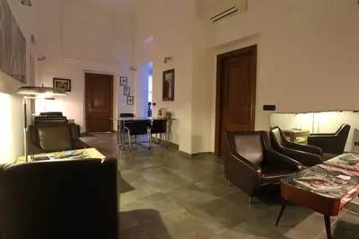 a living room with leather chairs and a table at Mr Frills in Rome