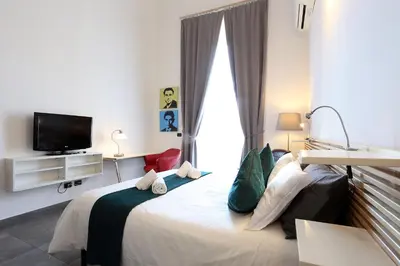 a bedroom with a large bed with a tv on it at Mr Frills in Rome