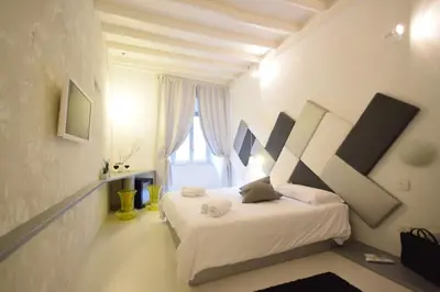 a blue and white bathroom with a toilet and a shower at Design&Art Pie' - Elegant Rooms Near the Pantheon, Calm & Central Stay in Rome