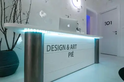 a desk with a sign for a design and art pier at Design&Art Pie' - Elegant Rooms Near the Pantheon, Calm & Central Stay in Rome