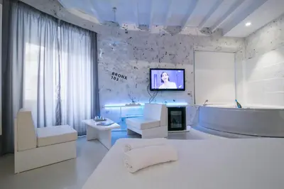 a bathroom with a tub and a tv on a wall at Design&Art Pie' - Elegant Rooms Near the Pantheon, Calm & Central Stay in Rome