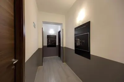 a hallway with two paintings on the wall at MF Hotel in Rome