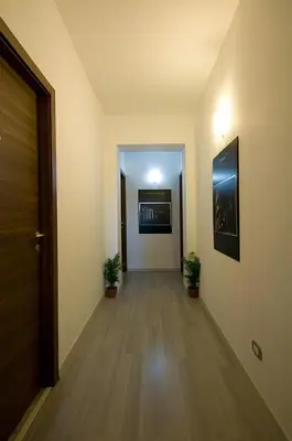 an empty hallway with two potted plants and a door at MF Hotel in Rome