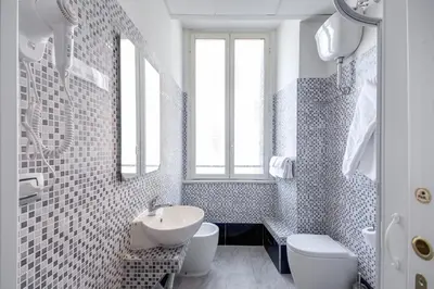 a white bathroom with a sink and a toilet at MF Hotel in Rome