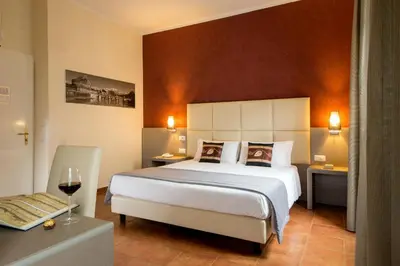 a bedroom with a large white bed and a table at Hearth Hotel in Rome
