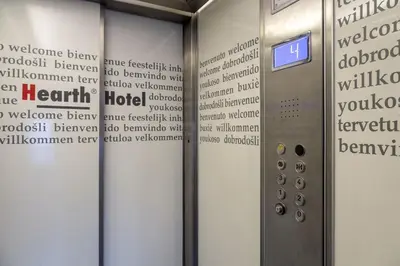 a elevator in a building with a welcome sign at Hearth Hotel in Rome