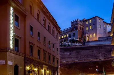 a building with a neon sign on the side of it at Hearth Hotel in Rome
