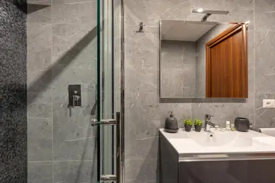 a bathroom with a shower and a sink and a mirror at Fornaci Vatican Flat in Rome