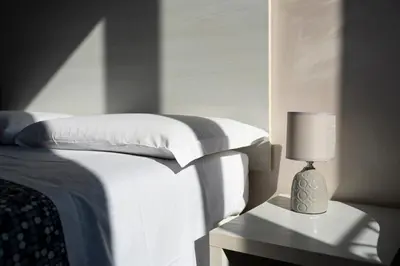 a bedroom with a bed and a lamp on a table at St. Peter Central Rooms B&B in Rome