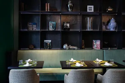 a dining room with two tables and chairs and shelves at Rome Times Hotel in Rome