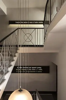 a chandelier in a hallway with a staircase at Rome Times Hotel in Rome