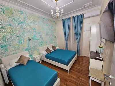 a bedroom with two beds and a wall mural at AL Holiday Home in Rome